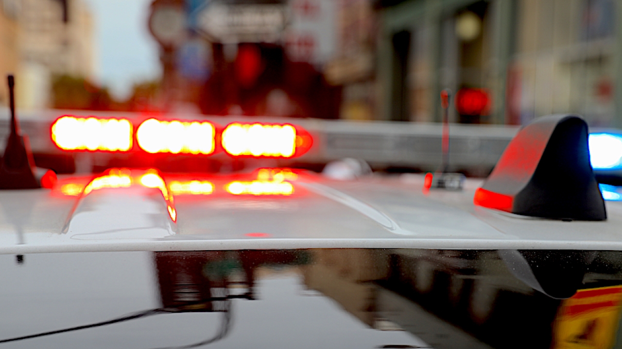 Top of a poilce car with red and blue lights glowing