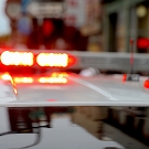 Top of a poilce car with red and blue lights glowing
